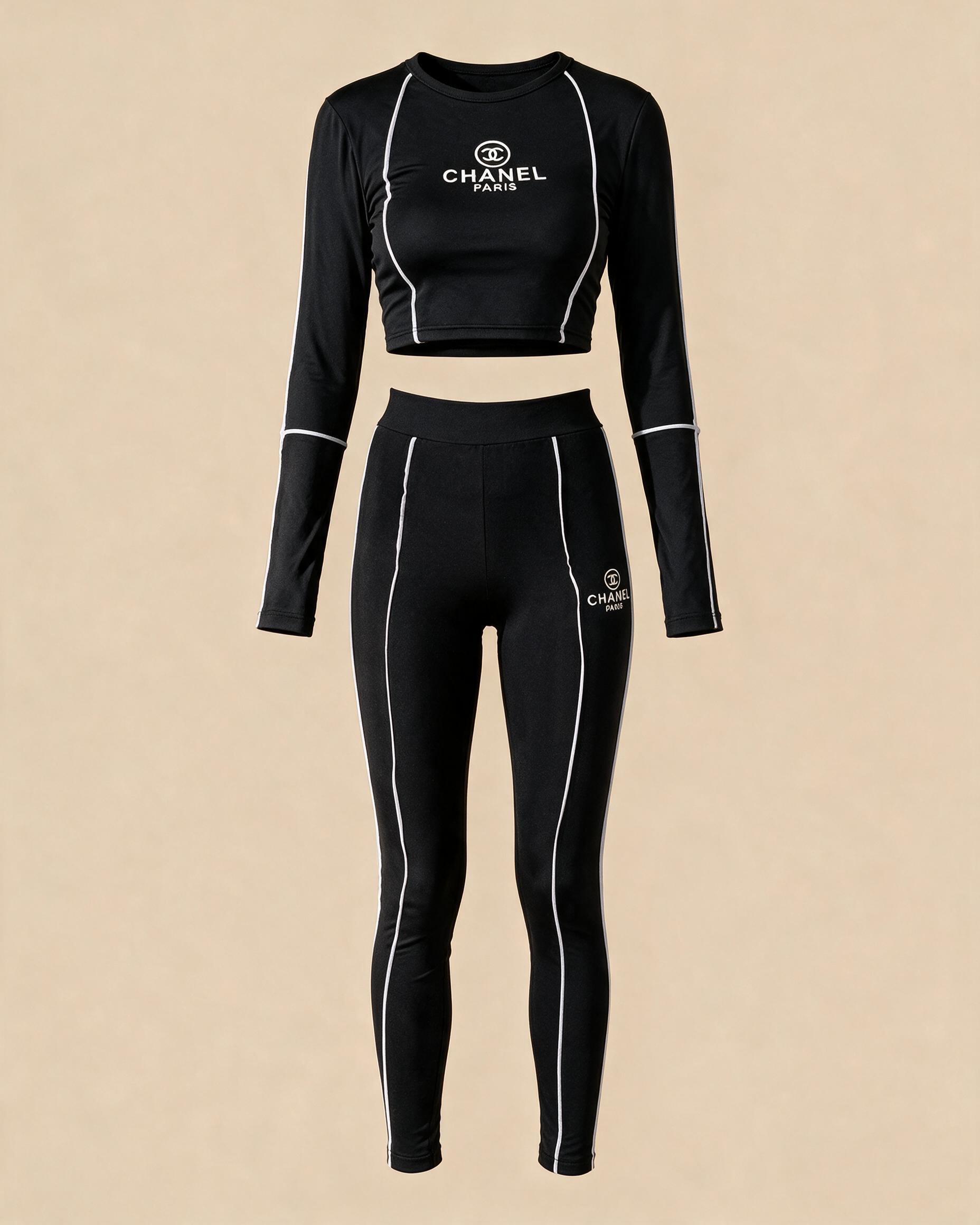 Completo sportivo da donna, top crop e leggings neri con profili bianchi · Usato
